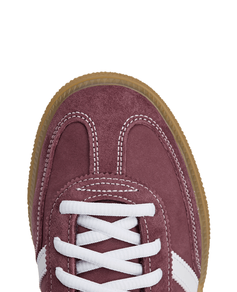 Close-up of the shadow red suede toe box and white laces on the adidas x Sporty & Rich Handball Spezial.