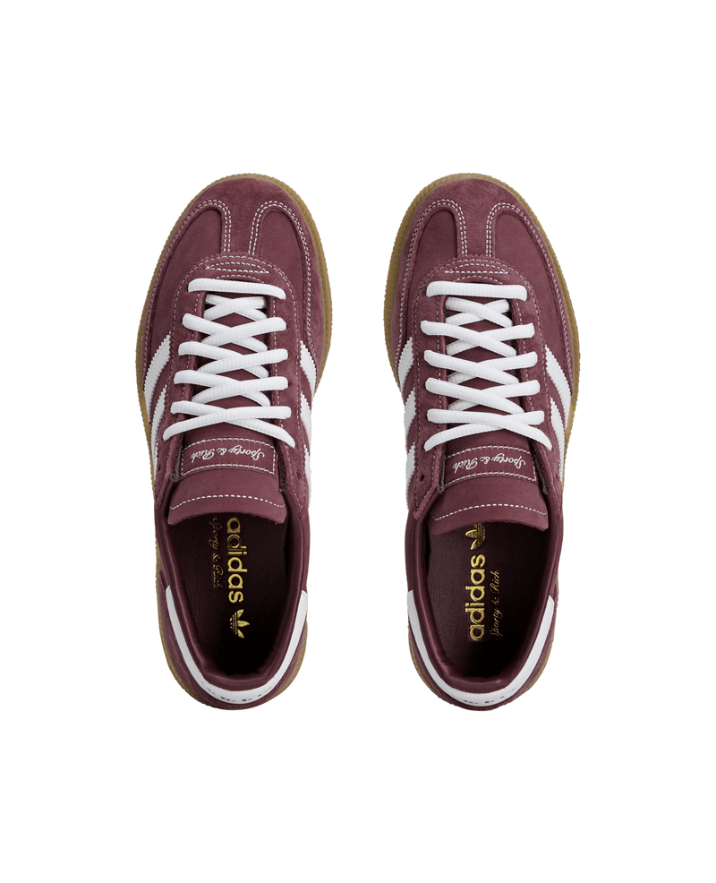 Top-down view of adidas x Sporty & Rich Handball Spezial sneakers in Shadow Red suede with white laces.