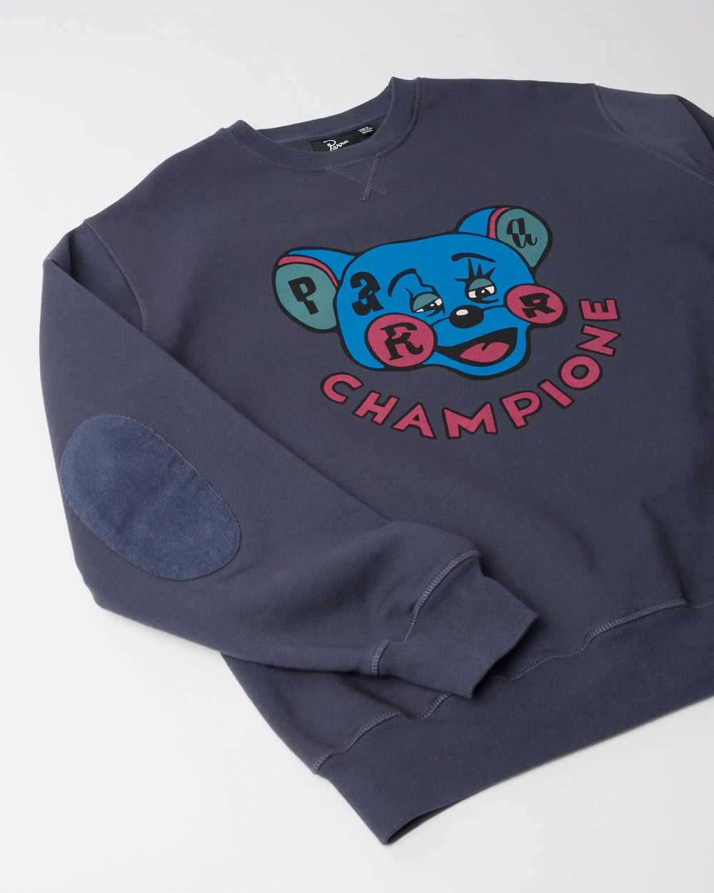Detailed view of the byParra Tired Champione navy blue crew neck sweatshirt showing the chest graphic.